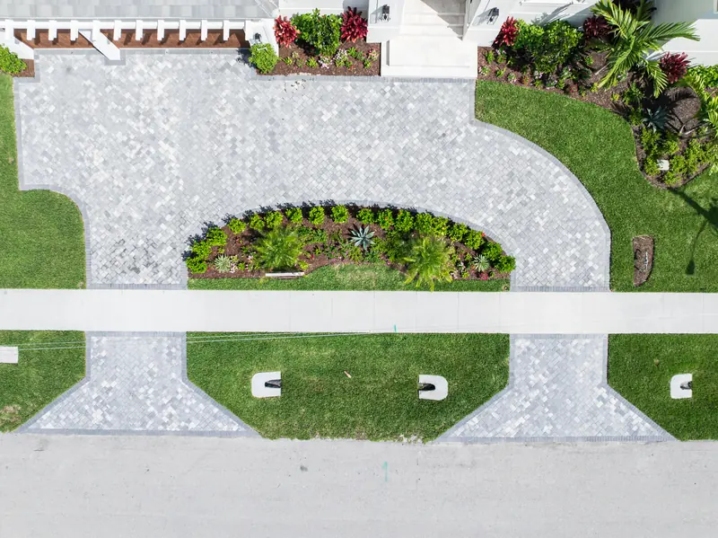 Overhead view of a planted island bed surrounded by a paver driveway